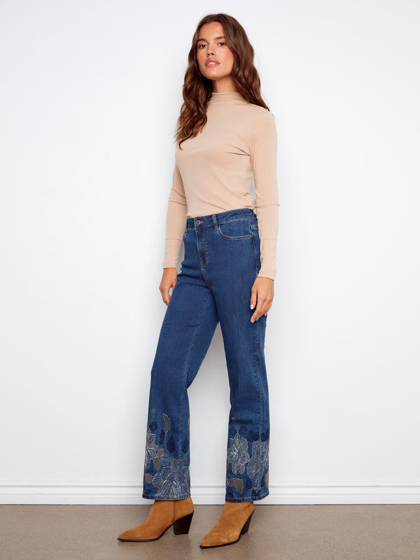Regular rise indigo jeans with stunning metallic floral patterns at the hem, crafted for comfort and style by Charlie B.