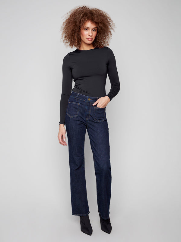 Deep blue jeans featuring a flattering flare leg and rivet accents, crafted from stretch denim for comfort by Charlie B.