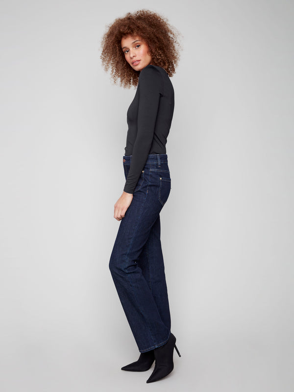 Classic deep blue jeans with regular rise and special rivets, designed for both style and comfort by Charlie B.