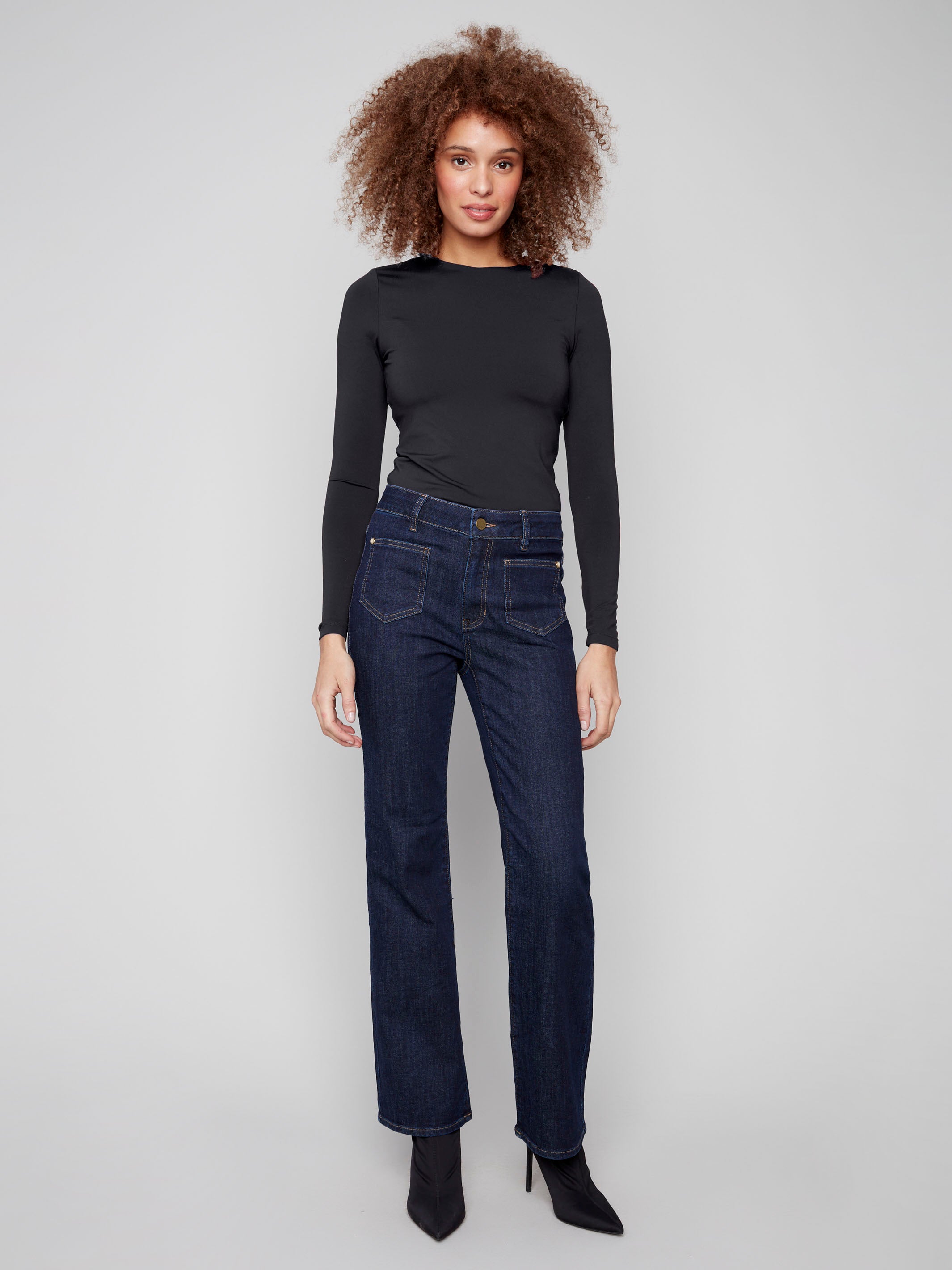 Elegant deep blue jeans showcasing back pockets and a modern flare leg design in stretch denim by Charlie B.