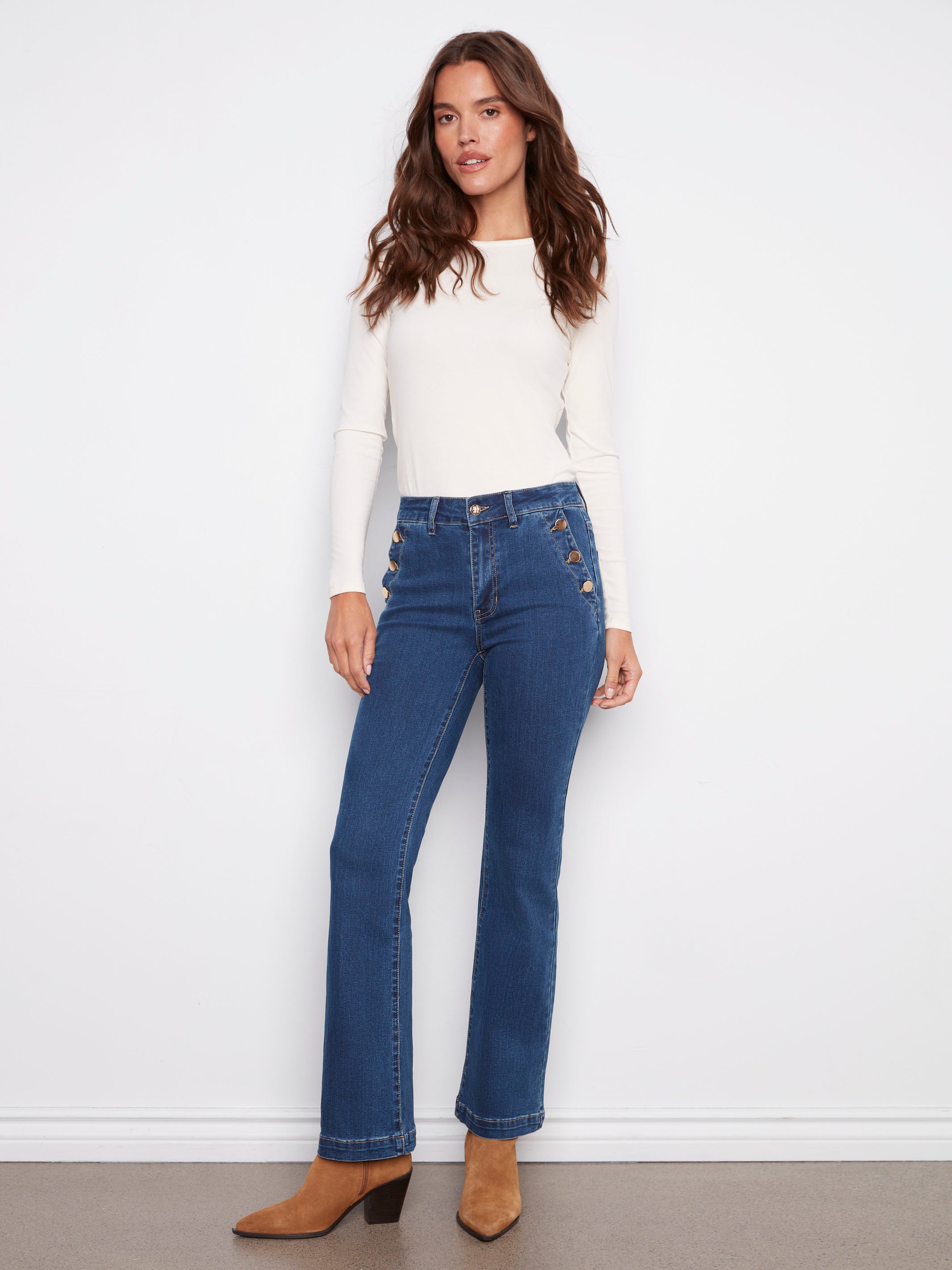 Indigo jeans featuring a regular rise and button details, paired with stylish boots, designed by Charlie B.