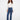 Indigo jeans featuring a regular rise and button details, paired with stylish boots, designed by Charlie B.