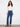 Indigo jeans featuring a regular rise and button details, paired with stylish boots, designed by Charlie B.