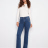 Indigo jeans featuring a regular rise and button details, paired with stylish boots, designed by Charlie B.
