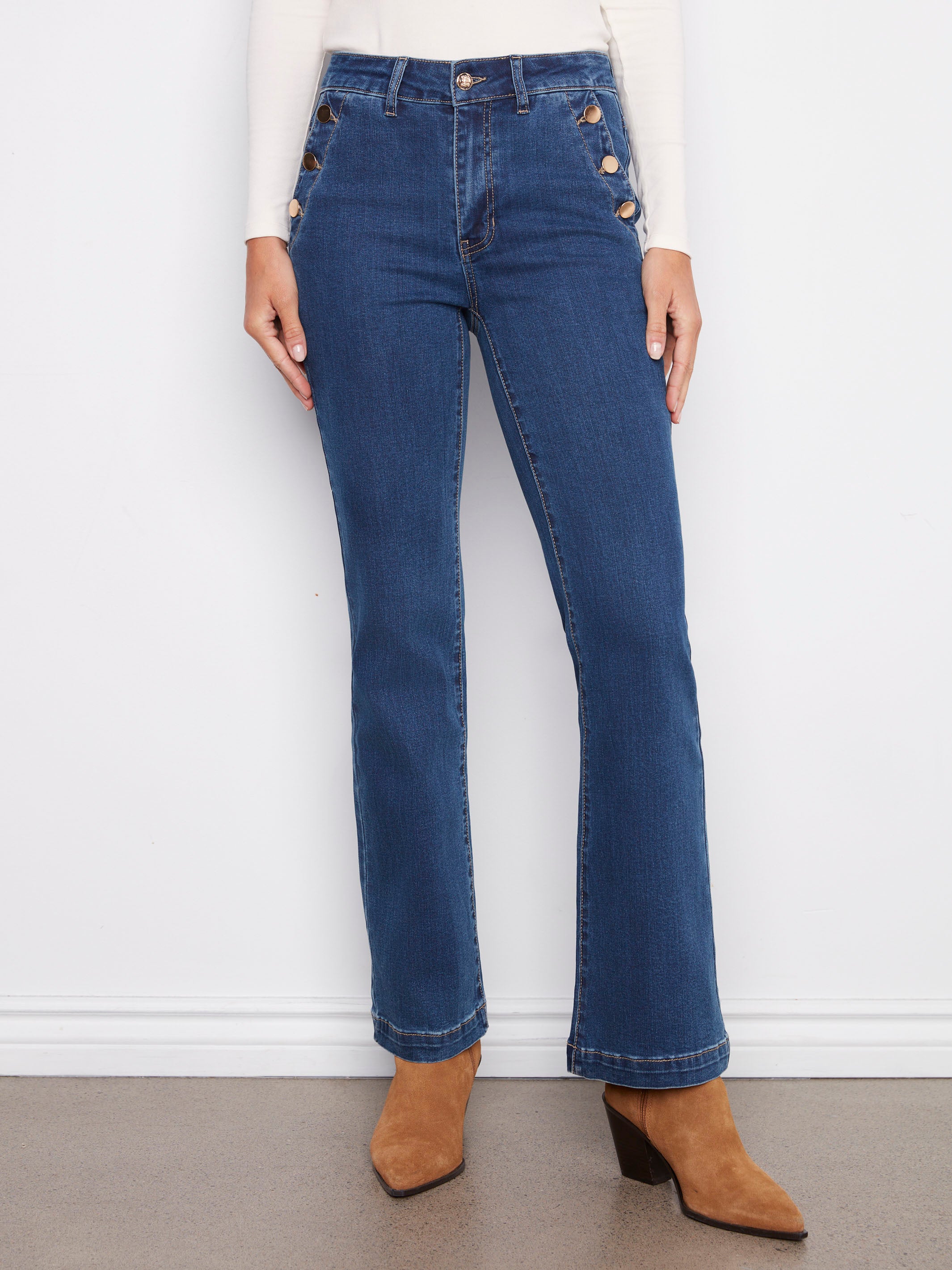 Stretch denim indigo jeans with side pockets and button accents, elegantly styled for a chic look by Charlie B.