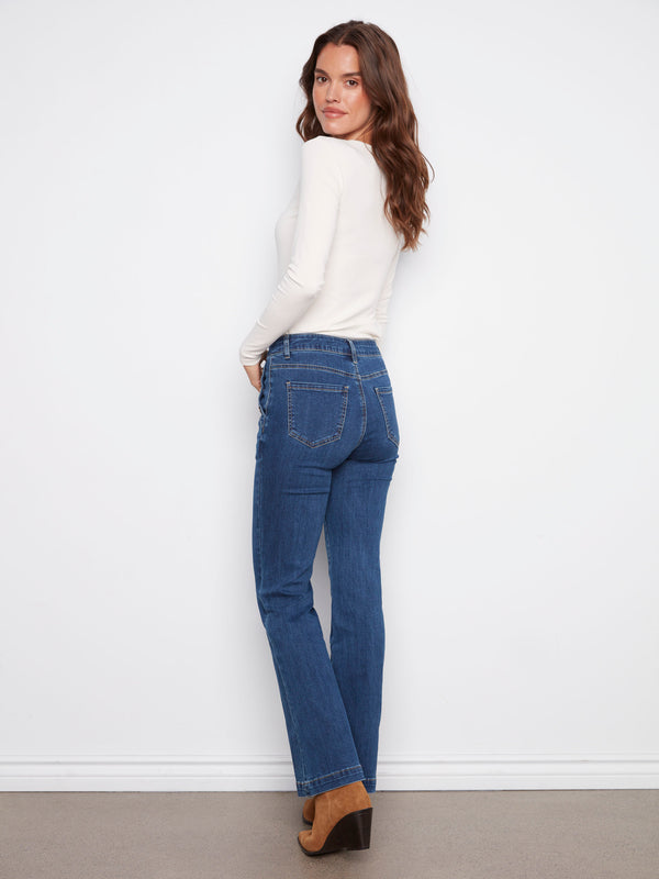Indigo flare leg jeans showcasing stylish button details on the pockets for an elevated look by Charlie B.
