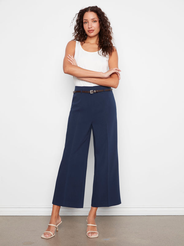 Stretch fabric navy dressy pants in cropped length, designed with wide legs and a chic belted waist by Charlie B.