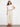 Featuring a belted waist, these beige pants offer both style and functionality for everyday wear. A versatile addition by Charlie B.