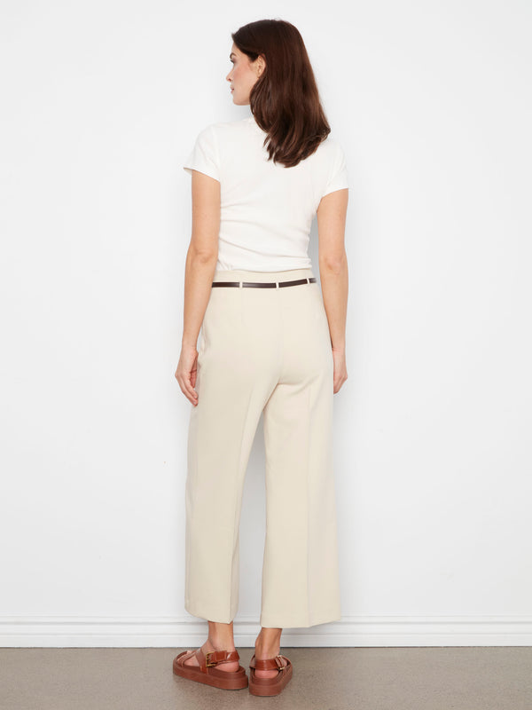 Crafted from stretch fabric, these beige pants ensure comfort and flexibility throughout your day while looking stylish. By Charlie B.