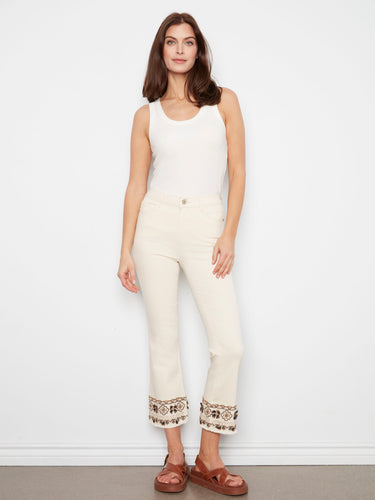 Natural-colored cropped pants made from stretch twill, complete with detailed embroidery at the hemline by Charlie B.