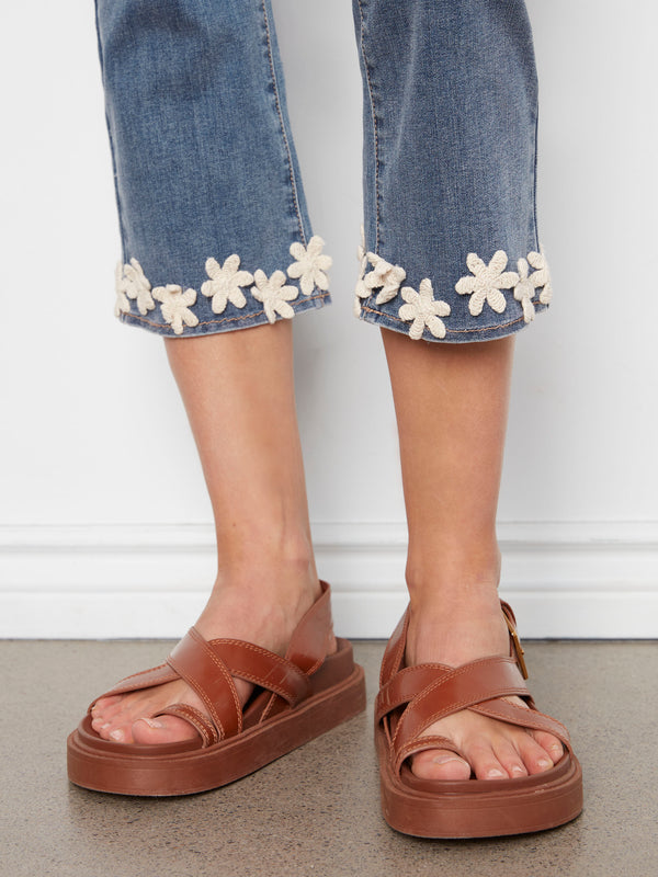 Stretch denim jeans in medium blue with regular rise, adorned with charming floral embroidery at the hem by Charlie B.