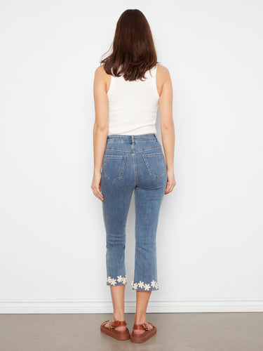 Versatile cropped flare jeans in medium blue, highlighted with intricate floral hem detailing for a chic look by Charlie B.