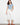 White pants with a flared leg, featuring intricate lace hem detail for added elegance. Crafted from stretch twill fabric by Charlie B.