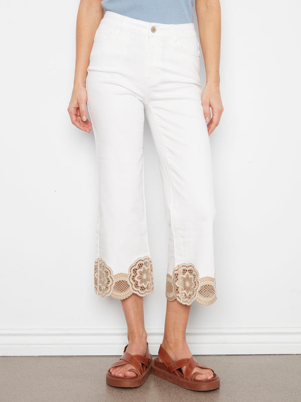 These cropped length white pants boast a delightful lace hem, offering both style and comfort in stretch twill fabric by Charlie B.