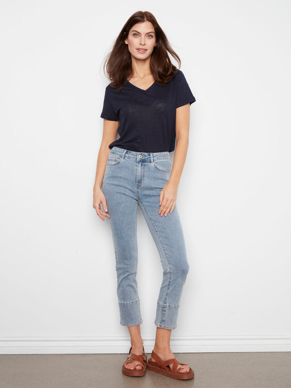 Light blue jeans with a slim fit, featuring a chic blanket stitch hem for added style by Charlie B.