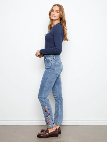 These jeans feature an ankle length design with intricate floral embroidery, perfect for a stylish look by Charlie B.