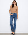 Full length indigo jeans with floral embroidery and scalloped hem, offering a stylish touch by Charlie B.