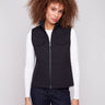 Black vest with quilted floral design, highlighted by convenient welt pockets and stylish high collar by Charlie B.