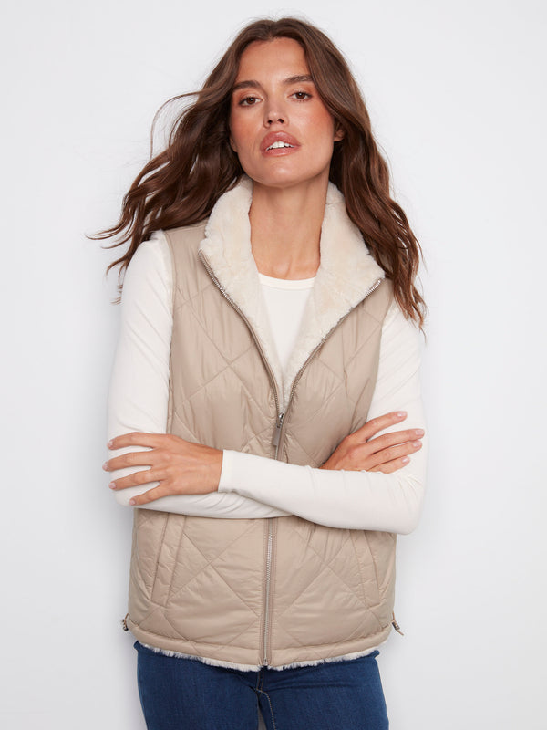 Chic greige faux fur reversible vest highlighting its stylish welt pockets by Charlie B.