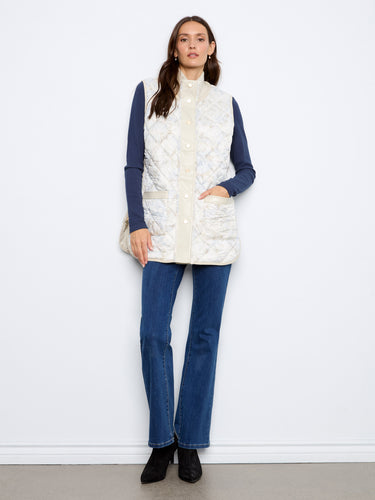 Quilted sleeveless vest featuring a snap-button closure, perfect for layering over casual outfits. By Charlie B.