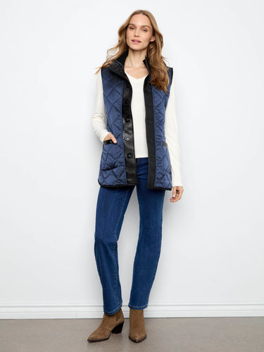Quilted vest with snap-button closure, offering a sleek and modern look for versatile styling. By Charlie B.
