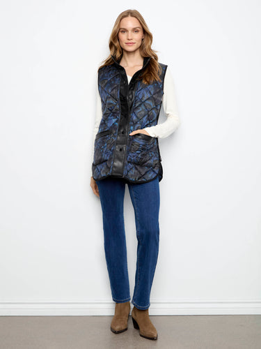 Side zipper details give an edgy twist to this classic sleeveless quilted outerwear piece. By Charlie B.