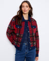 Red plaid jacket with a classic button-front closure, offering both style and functionality. Designed by Charlie B.