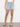 These light blue shorts feature five pockets and detailed floral embroidery, combining function with fashion by Charlie B.