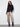 Fashion-forward black sweater with eye-catching gold metallic stripes and stylish button accents by Charlie B.