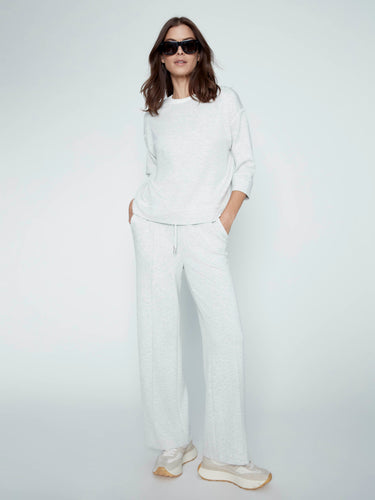 Featuring an elastic waistband with drawstrings, these trousers combine practicality with modern design aesthetics. By Charlie B.