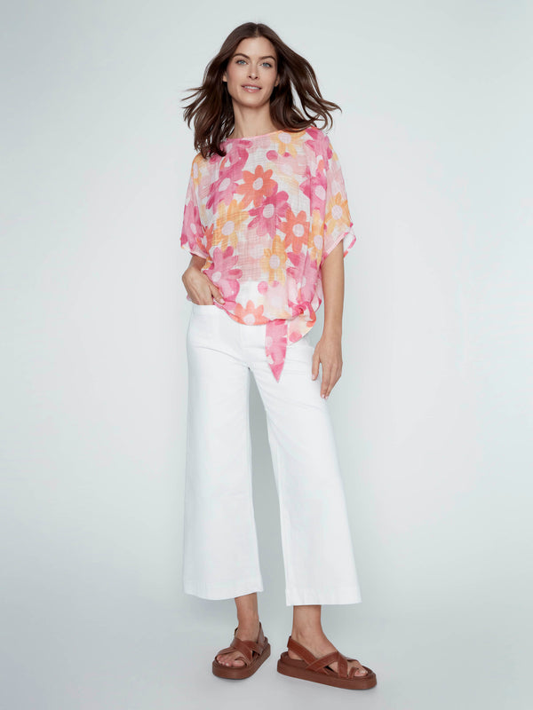 Model wearing a floral print top made from soft cotton blend, matched with relaxed-fit pants by Charlie B.