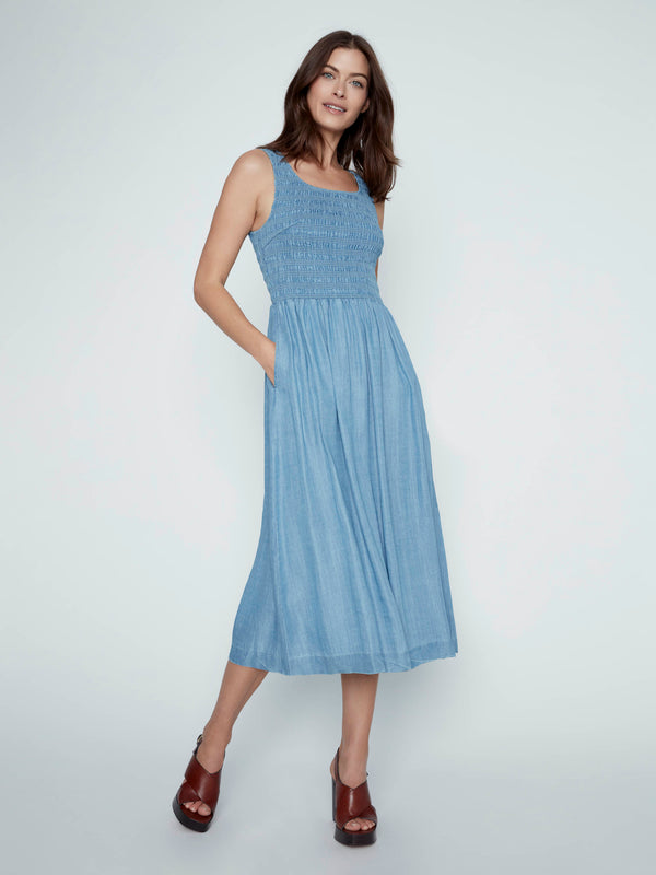 Stylish blue Tencel maxi dress with practical side pockets and a charming smocked bodice by Charlie B.