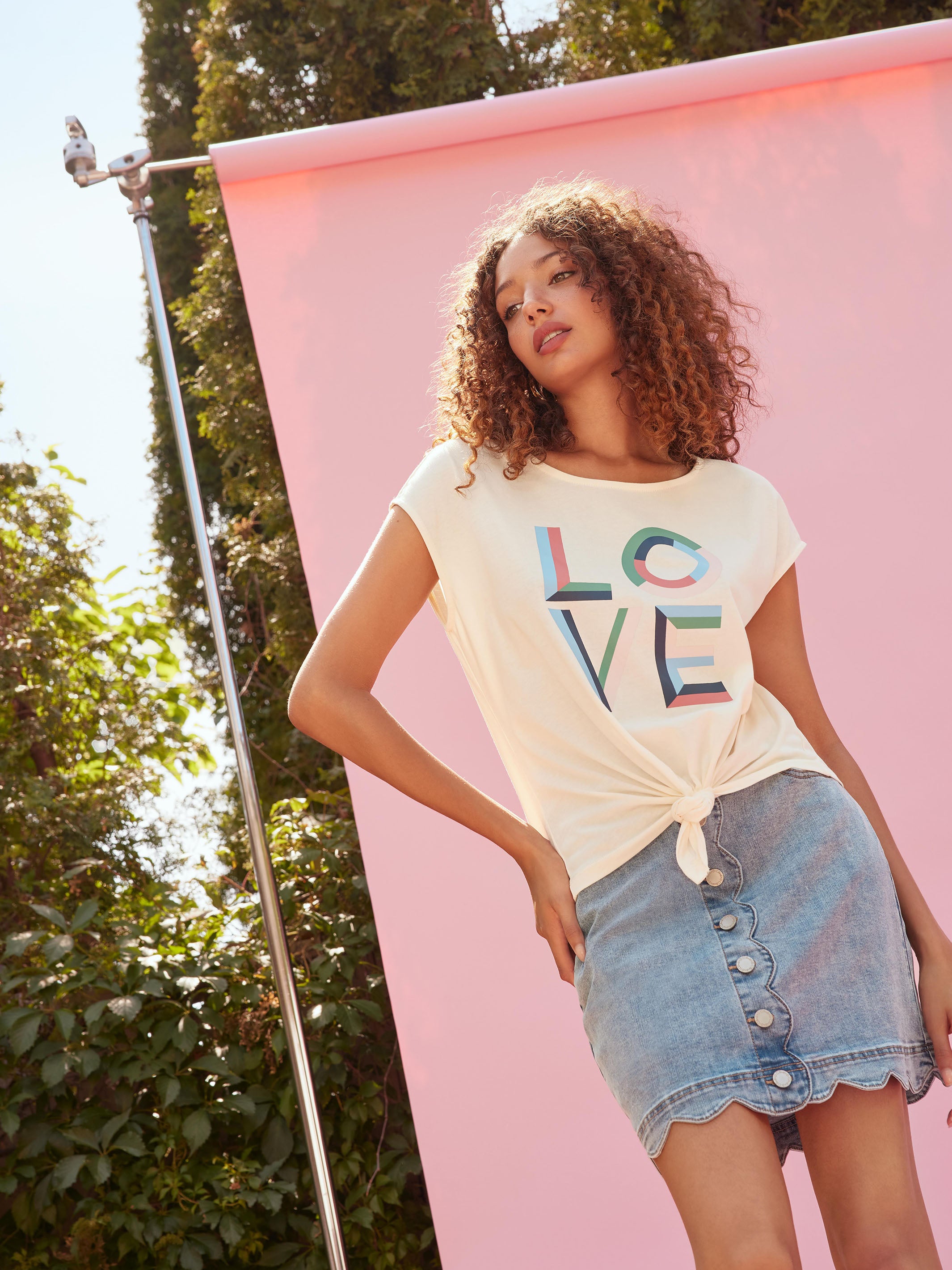 Fashionable white top highlighting a colorful motif design by Charlie B.
