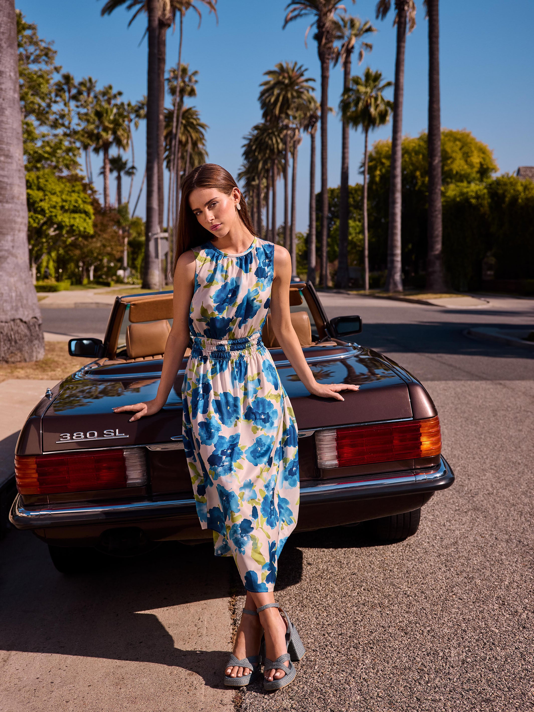 Elegant sleeveless design on a flowy floral midi dress by Charlie B.
