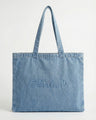 Denim tote bag crafted from 100% cotton, showcasing the embossed Charlie B logo. Features carry handles for easy portability by Charlie B.