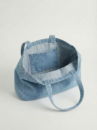 Made from durable 100% cotton, this denim tote bag features an embossed logo and practical dimensions of 16" x 12.75" x 3" by Charlie B.