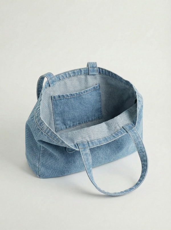 Made from durable 100% cotton, this denim tote bag features an embossed logo and practical dimensions of 16" x 12.75" x 3" by Charlie B.