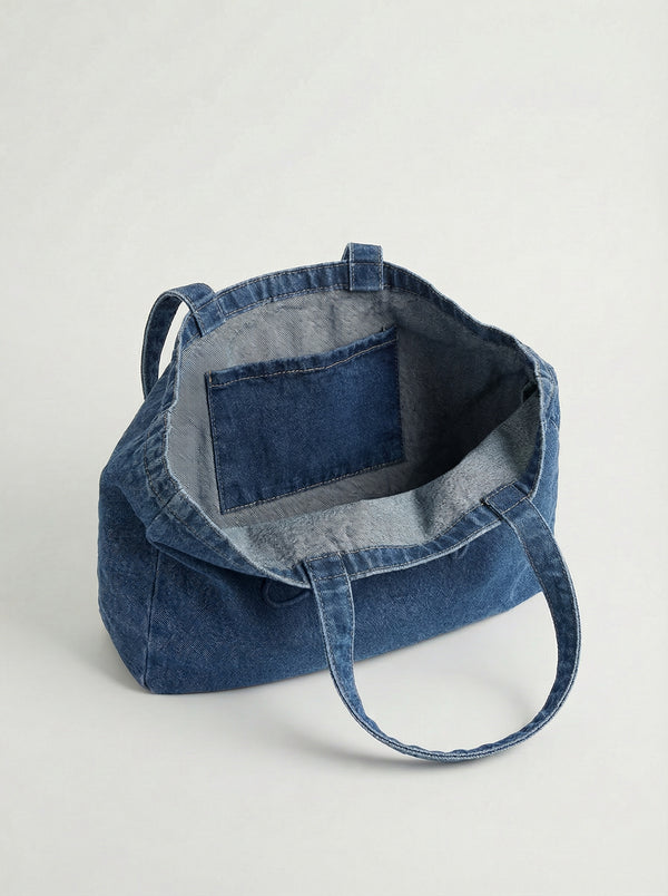 Open view of the denim tote highlighting the interior pocket for extra storage. Ideal for organizing essentials by Charlie B.