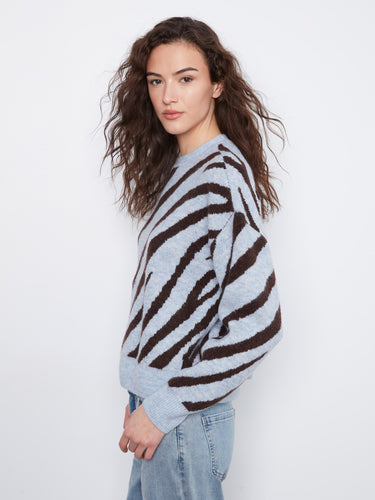 This cozy knit features a unique design that combines fashion and comfort effortlessly. By Charlie B.