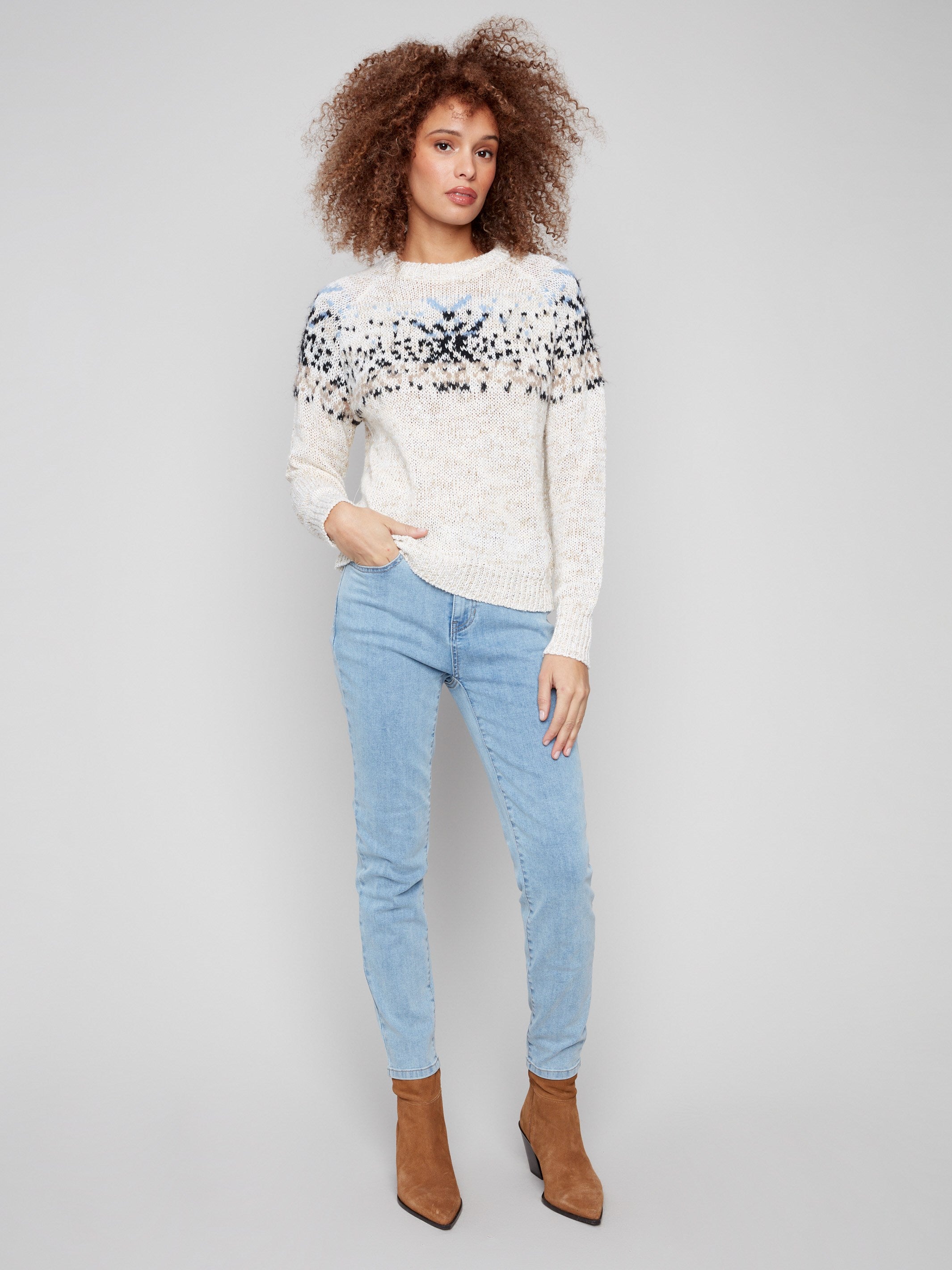 Stylish ecru sweater showcasing elegant raglan sleeves and geometric patterns by Charlie B.