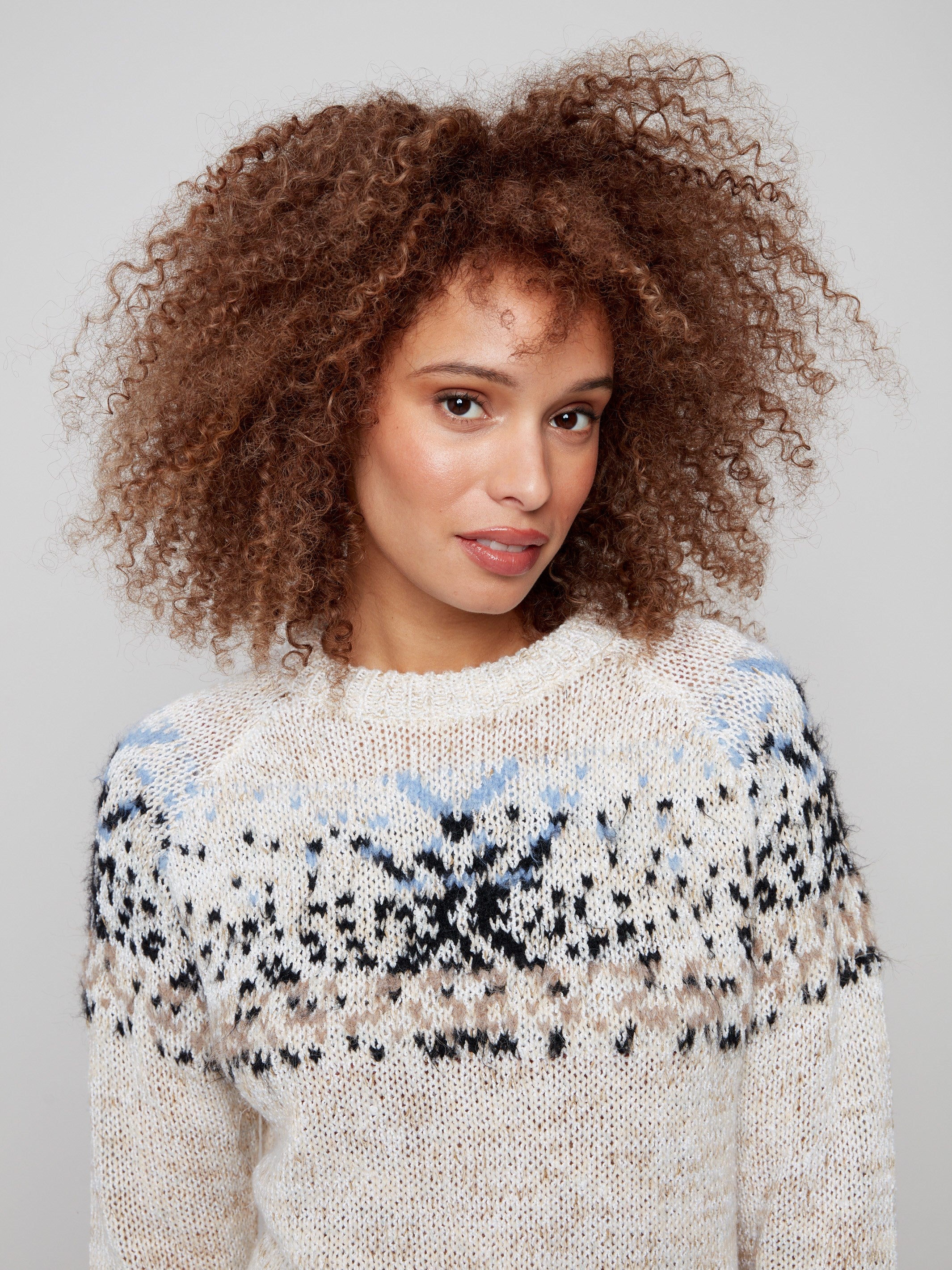 Elegant ecru sweater highlighting the geometric design in plush knit fabric by Charlie B.
