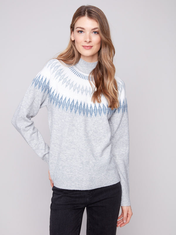 Light grey sweater with a geometric jacquard pattern and cozy mock neck, offering a stylish relaxed fit by Charlie B.