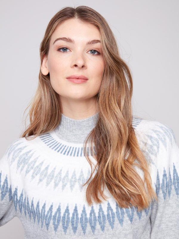 Elegant light grey sweater with a mock neck, showcasing a unique geometric pattern for added style by Charlie B.