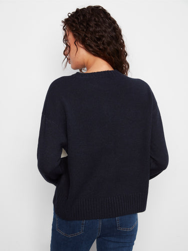 Back view of the sweater showing its solid color design, offering versatility and style for any occasion by Charlie B.
