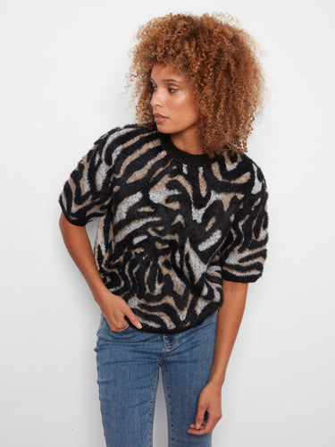 With its relaxed fit and stylish design, this versatile sweater is ideal for layering or wearing alone. By Charlie B.