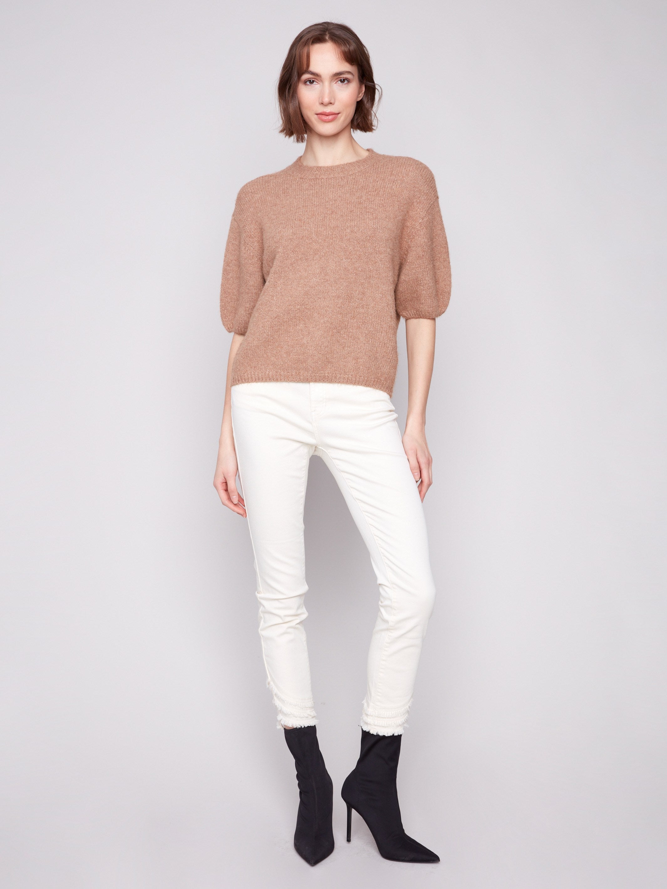 Elegant balloon-shaped elbow sleeves add a stylish touch to this knit sweater by Charlie B.