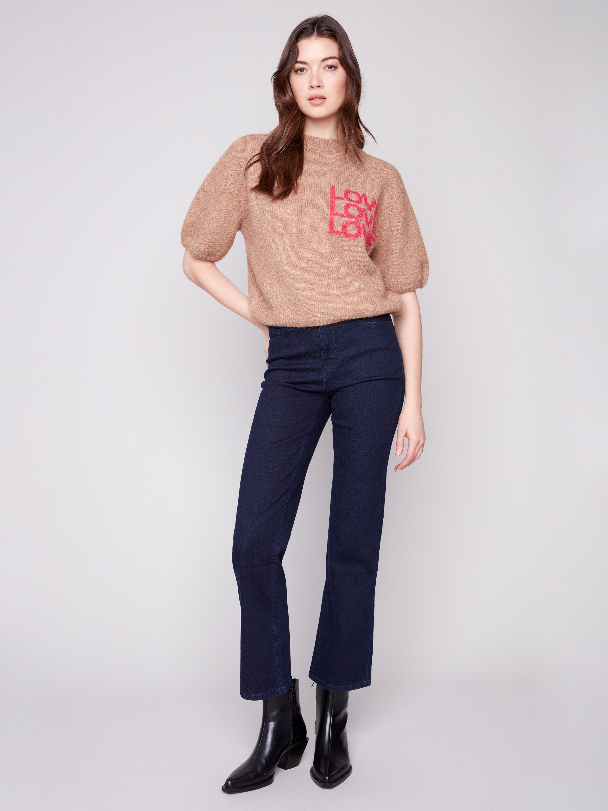 Plush knit truffle sweater featuring balloon-shaped elbow sleeves and vibrant graphic text by Charlie B.