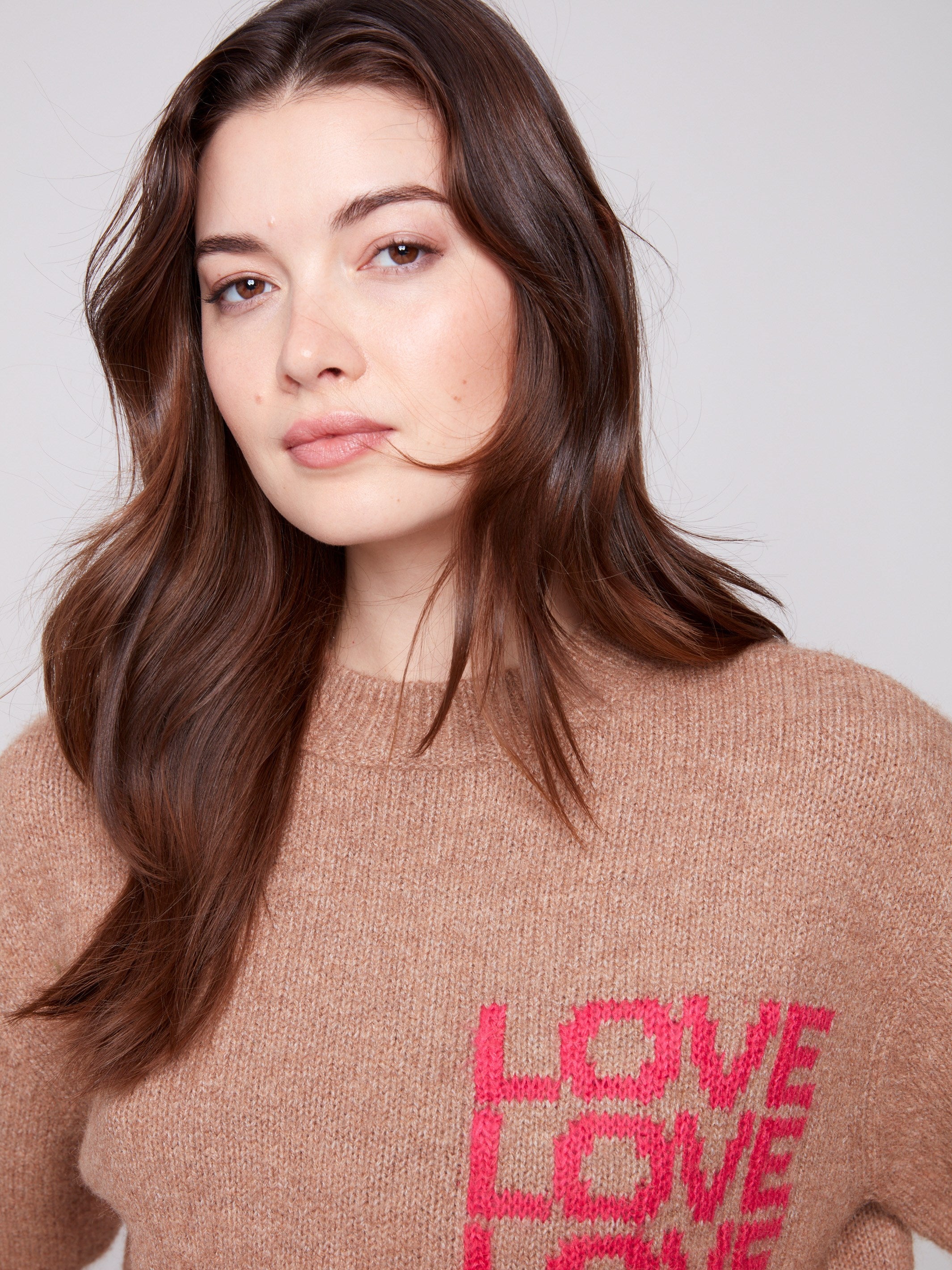 Relaxed fit truffle sweater with bold 'LOVE' text, offering comfort and style in plush knit by Charlie B.