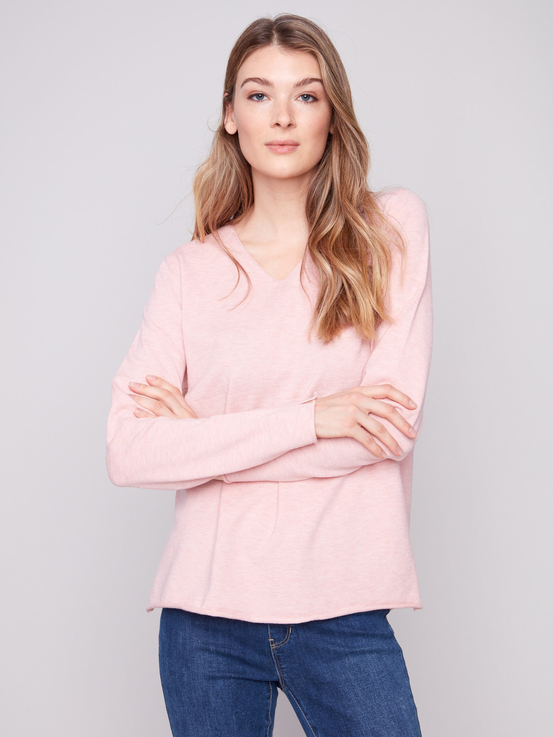 Sophisticated sweater with side slits on sleeves and hem, adding a touch of flair by Charlie B.