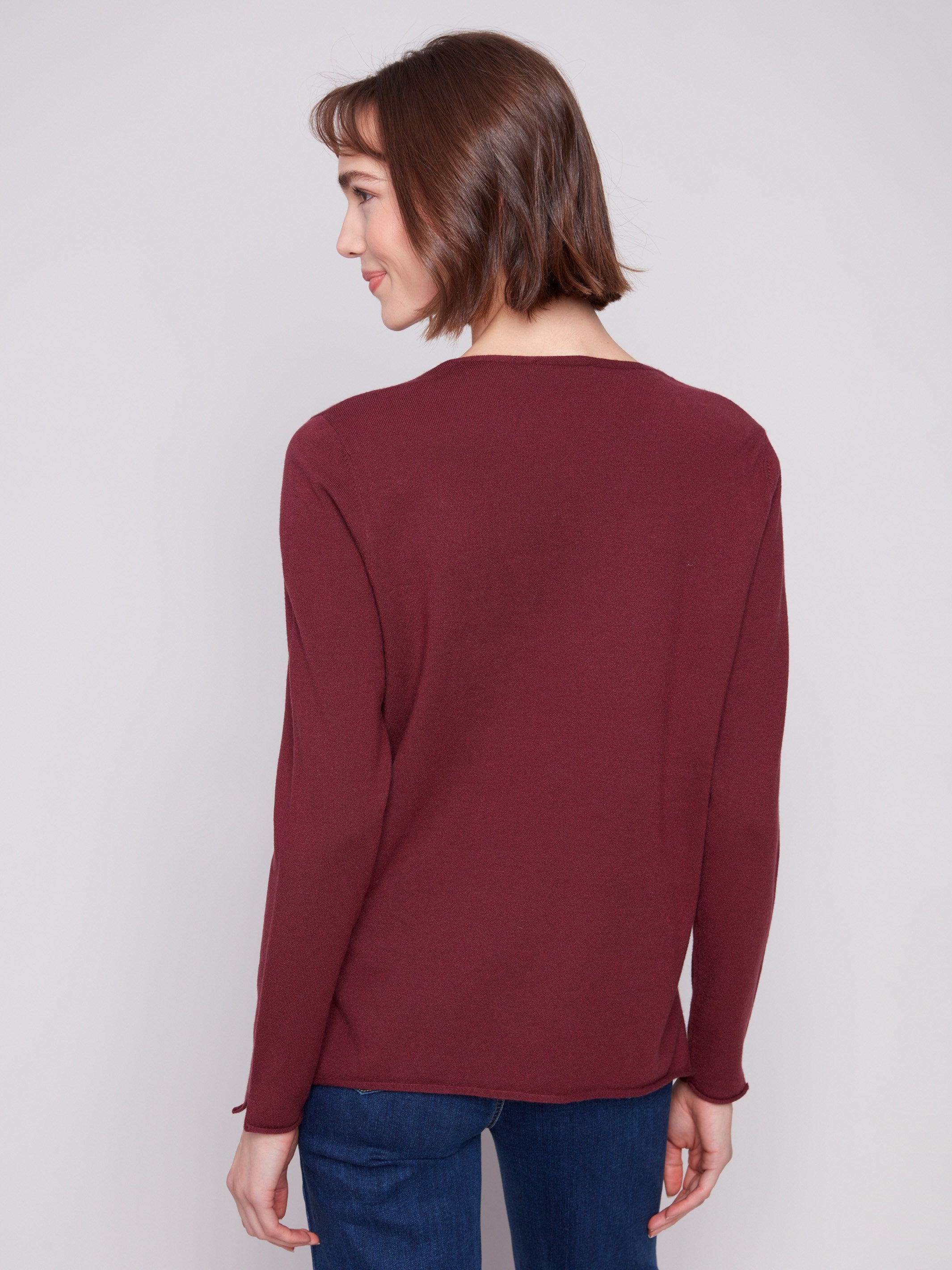 Stylish Cabernet sweater showcasing side slits on hem, adding a modern touch to its timeless design by Charlie B.